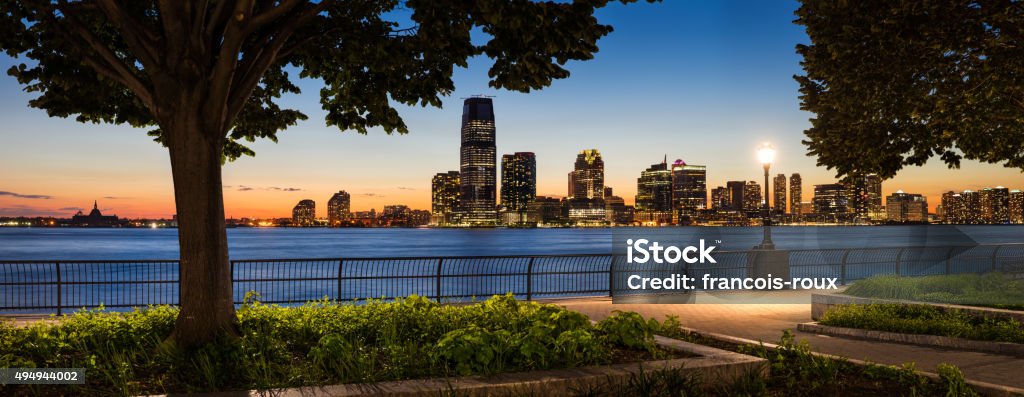 Sunset view from Manhattan of Jersey City and Hudson River waterfront with skyscrapers.